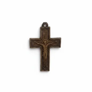 Old bronze crucifix with Jesus Christ, hanging loop at top, on white.