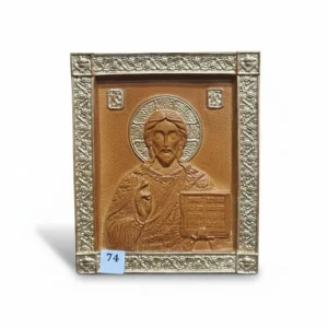Bronze relief icon of Jesus Christ blessing and holding open Gospels in ornate metallic frame.